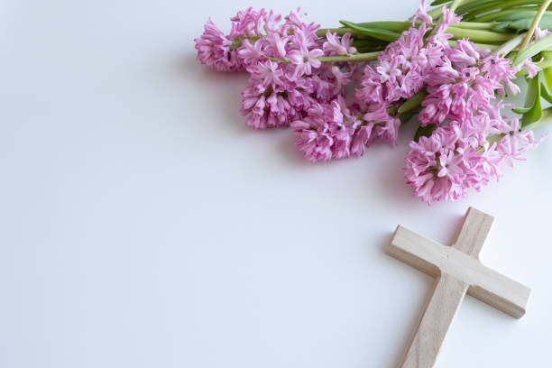 istock Wood cross and pink flowers 1456059793