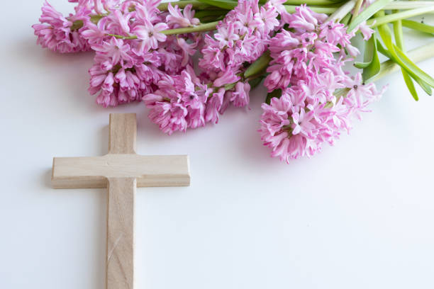 istock Wood cross and pink flowers 1456059800