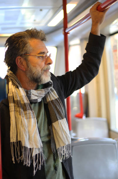 istock Senior man in city bus 1456059841