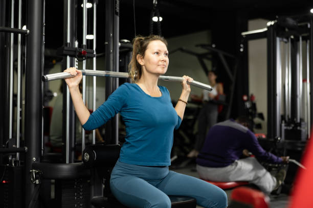 istock Woman is engaged in a simulator for development of back muscles 1456060032