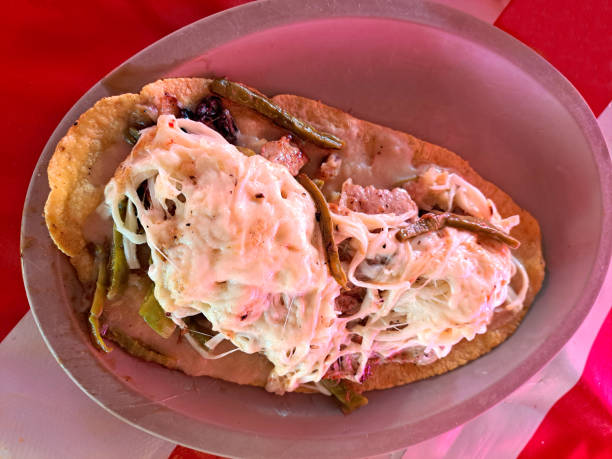 istock The huarache is a typical Mexican dish, whose shape simulates traditional Mexican sandals. It is made with corn dough, steak, or egg accompanied with sauce, cheese, and beans 1456060774
