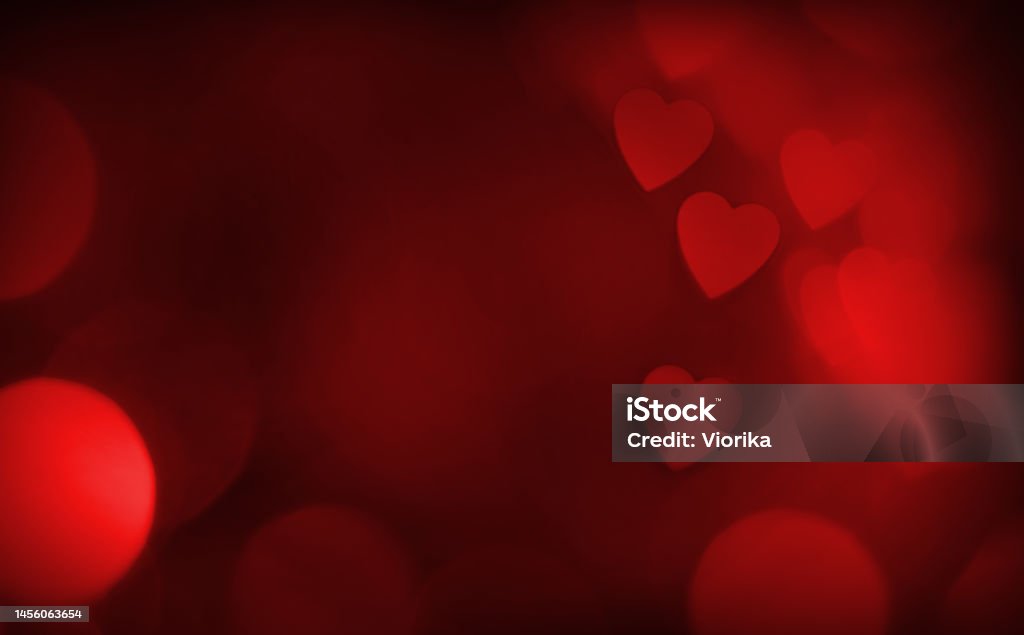 Red hearts defocused bokeh background with space for copy Red defocused bokeh background with heart shape and space for your text. Can be used as a template for romantic, Valentine's day holiday greeting cards or posters. Valentine's Day - Holiday Stock Photo