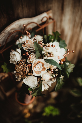 Flowers made out of wood in a wedding bouquet