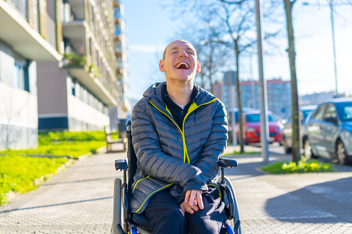 A disabled person enjoying walking on the street in a wheelchair, rehabilitation