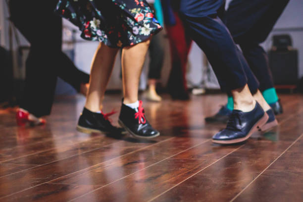 dancing shoes of young couple dance retro jazz swing dances on a ballroom club wooden floor, close up view of shoes, female and male, dance lessons class rehearsal - polka dancing imagens e fotografias de stock