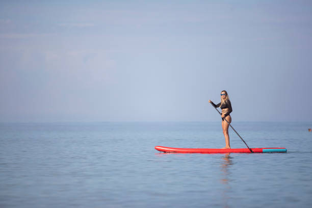 istock A female surfer enjoys peace and quiet while paddling on a SUP board 1456068001