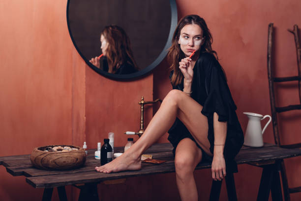 istock Young woman with patches under her eyes brushing her teeth 1456068024
