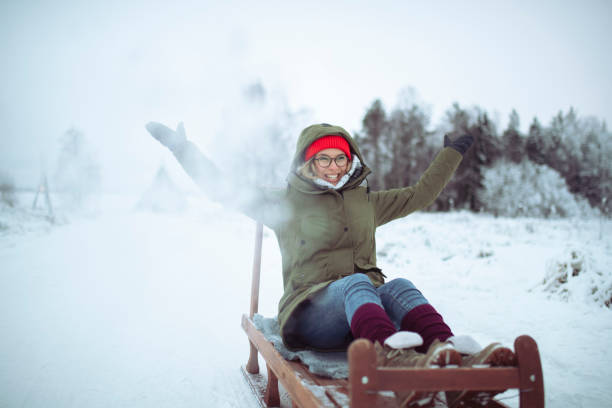 istock A woman is sledding and throwing snow, a winter idyll 1456068387
