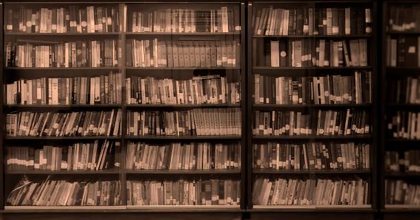 istock Defocused and blurred image of library books on shelves for use as background 1456068423