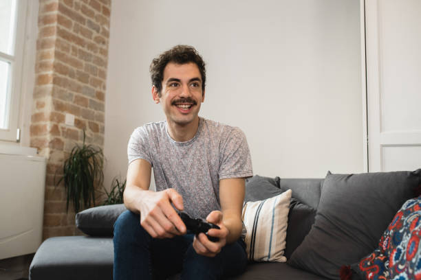 istock Portrait of a young man having fun playing video games 1456070608