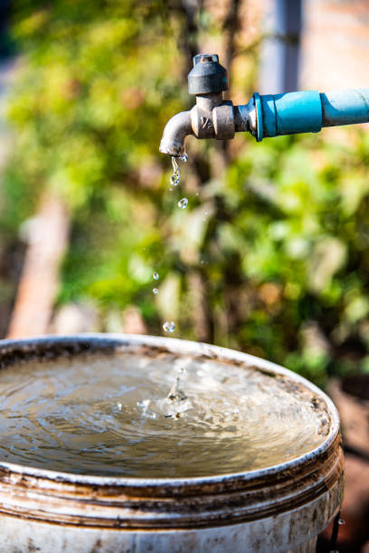 istock Water drop flowing from faucet 1456076064