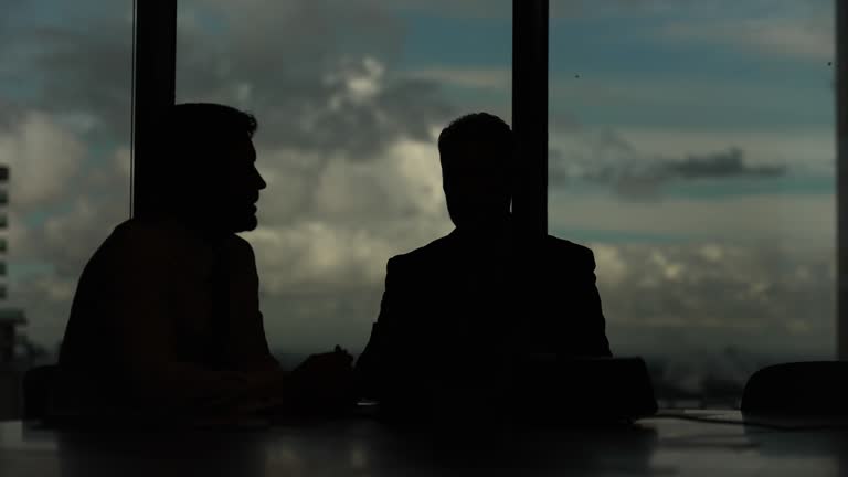 Silhouette of Two businessmen meeting