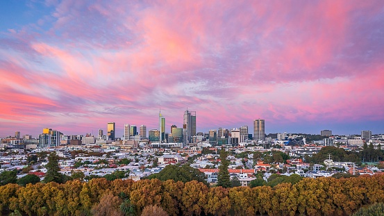 An aerial view of the skyline of Brisbane, Australia with a colorful and vibrant sky as the background