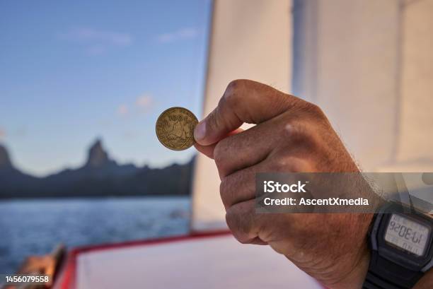 Hand With Digital Watch Holds Old Coin On Boat Stock Photo - Download Image Now - Adult, Adults Only, Blue