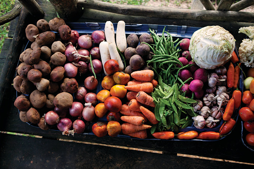 Looking down on a selection of raw vegetables on a box.