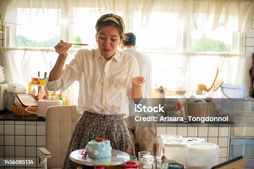 istock The woman tasted the cake she made and was amazed at how delicious it was. 1456085134