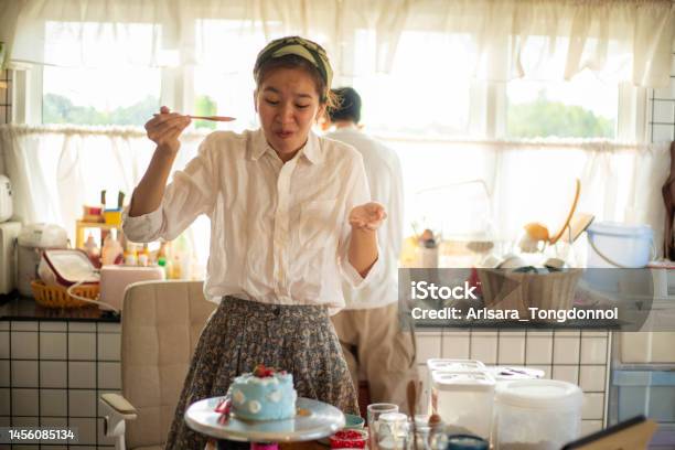 The Woman Tasted The Cake She Made And Was Amazed At How Delicious It Was Stock Photo - Download Image Now