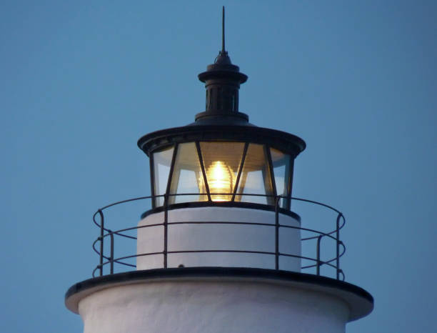 Ocracoke Lighthouse Beacon Close-up The beacon atop the historic Ocracoke Lighthouse is fully automated, its operation now overseen by the U.S. Coast Guard.  The light serves to guide ships through the Ocracoke Inlet, an estuary in the Outer Banks, North Carolina. ocracoke island stock pictures, royalty-free photos & images
