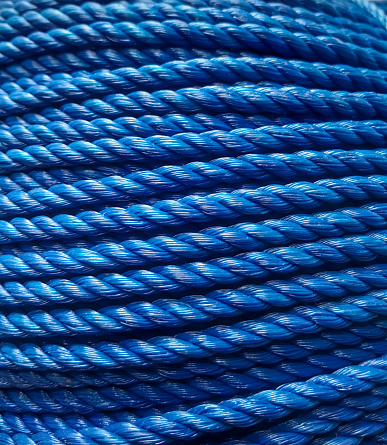 a roll of blue rope that looks abstract