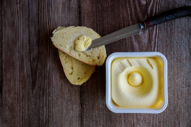 istock Creamy butter spread on slice of bread. 1456091550