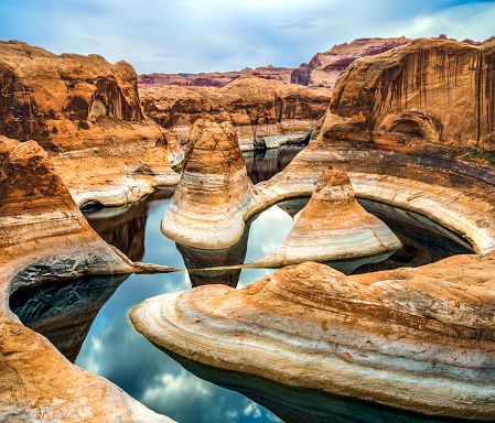 Lake Powell in the U.S.  The coast is cut by narrow canyons. Grandiose huge lake of artificial origin among the picturesque red sandstone cliffs.