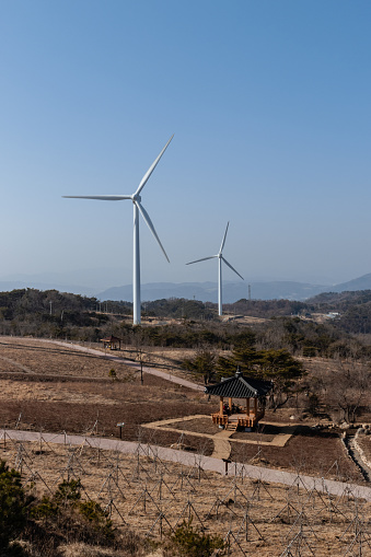 This is a photo of two wind turbines on top of a hill in Gyeongju, South Korea. A lot of wind turbines can be spotted across rural areas inside the country.