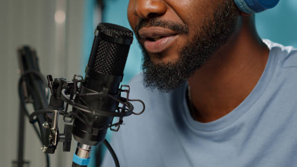 istock Close up of vlogger using microphone for online podcast 1456102311