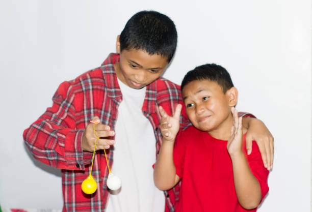A boy playing with her father on studio white background
