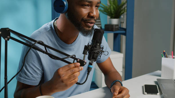 istock Close up of vlogger using microphone and headphones 1456102910