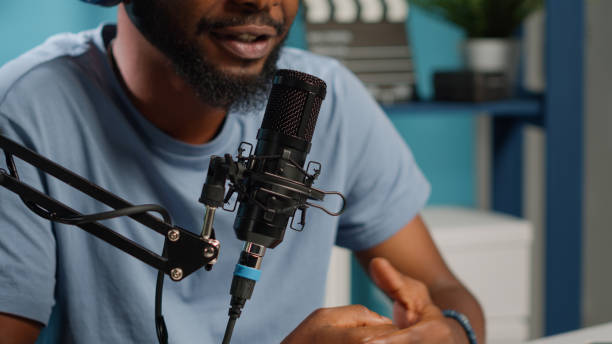 istock Close up of influencer using microphone to talk on online podcast 1456103084