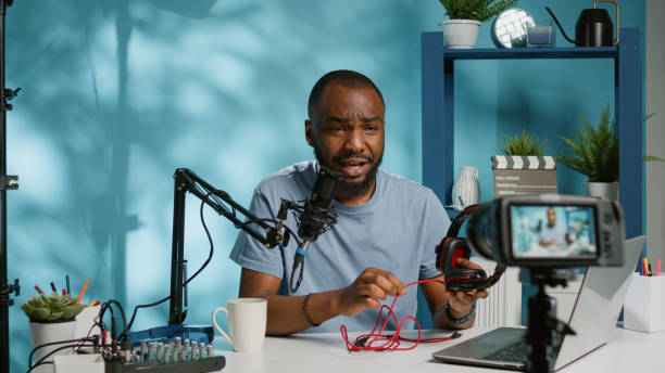 istock Blogger doing review for modern headphones on camera 1456103108