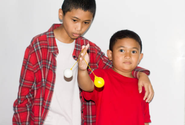 boy play the Lato-lato game which is a type of traditional game that is commonly found in Indonesia