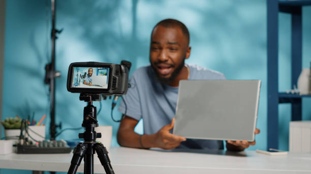 istock Close up of modern camera recording vlogger with laptop 1456103314