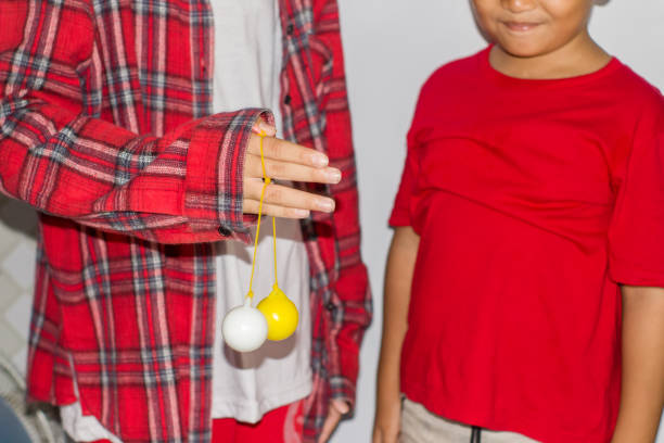 boy play the Lato-lato game which is a type of traditional game that is commonly found in Indonesia
