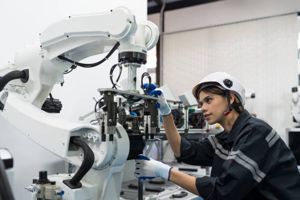 istock Female engineer control autonomous mobile robot or AMR in the manufacturing automation and robotics academy room. Woman engineer training or maintenance AI robot 1456108489