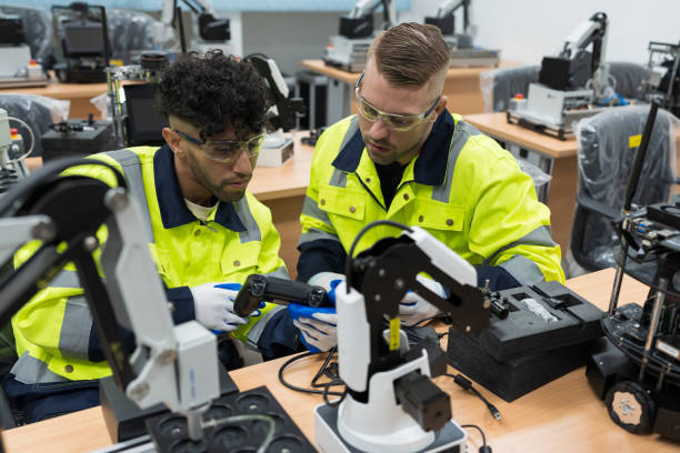 istock Two male engineers training or maintenance AI Robot and Artificial Intelligence of Things (AIoT) service robot in the manufacturing automation and robotics academy room 1456108593