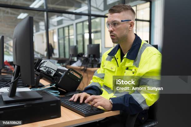Male Engineer Using Desktop Computer For Training Programmable Logic ...