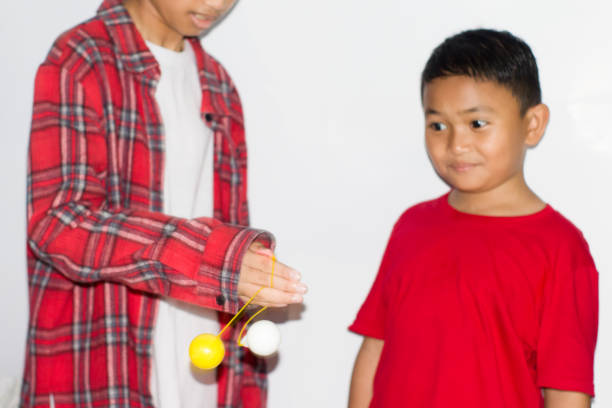 boy play the Lato-lato game which is a type of traditional game that is commonly found in Indonesia