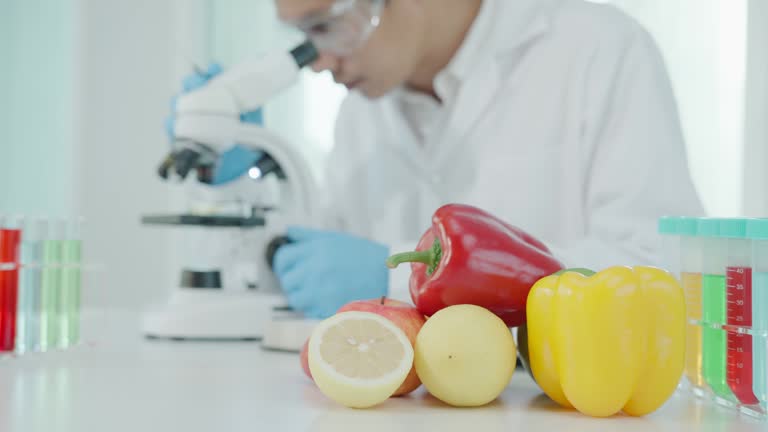 Scientist check chemical food residues in laboratory. Control experts inspect quality of fruits, vegetables. lab, hazards, ROHs, find prohibited substances, contaminate, Microscope, Microbiologist