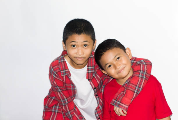 two asian boys friendship with isolated white background