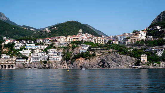 A wide angle view of a city on the water on the Amalfi Coast during summer