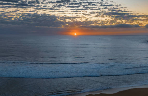 istock Beautiful sunrise with clouds over the ocean 1456110714