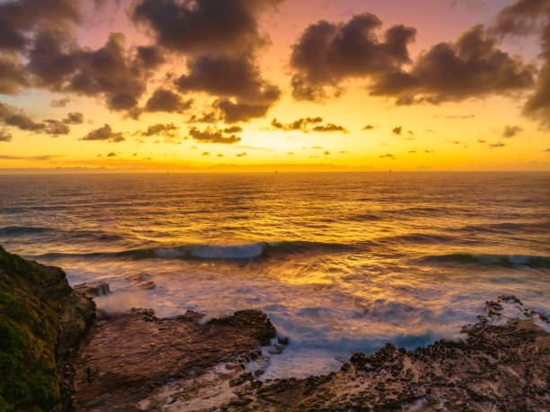 istock Surfs up sunrise at the seaside with scattered clouds 1456110829