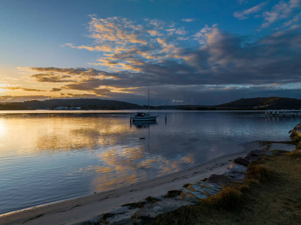 istock Sunrise over the bay with clouds and reflections 1456110966