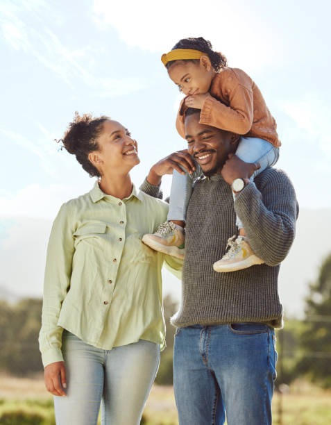 parents, kids and happy family in park, garden and sunshine field outdoors for bonding, love and quality time together. mom, dad and girl child of black family having fun, relax and care in nature - buitenopname fotos stockfoto's en -beelden