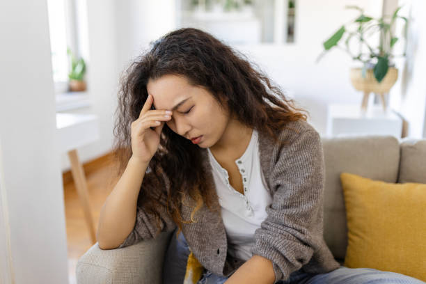 istock Sinus ache causing very paintful headache. Unhealthy Asian woman in pain. Sharp strong sore. Sinus pain, sinus pressure, sinusitis. Sad woman holding her head because sinus pain 1456112016