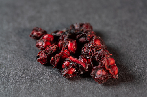 chinese medicine Schisandra chinensis, the fruit of Chinese magnoliavineon wooden table on black background