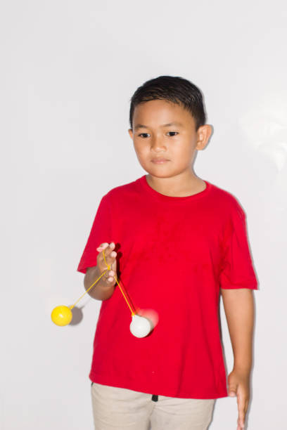 istock boy play the Lato-lato game 1456113891