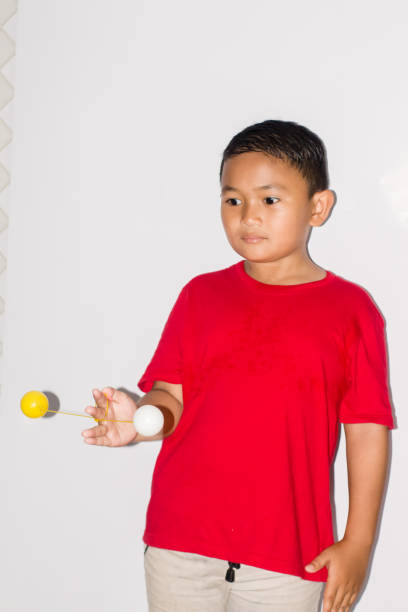 istock boy play the Lato-lato game 1456113932