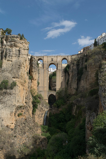 A head on view of the waterfall and bridge crossing at the heart of Ronda in Andalucia